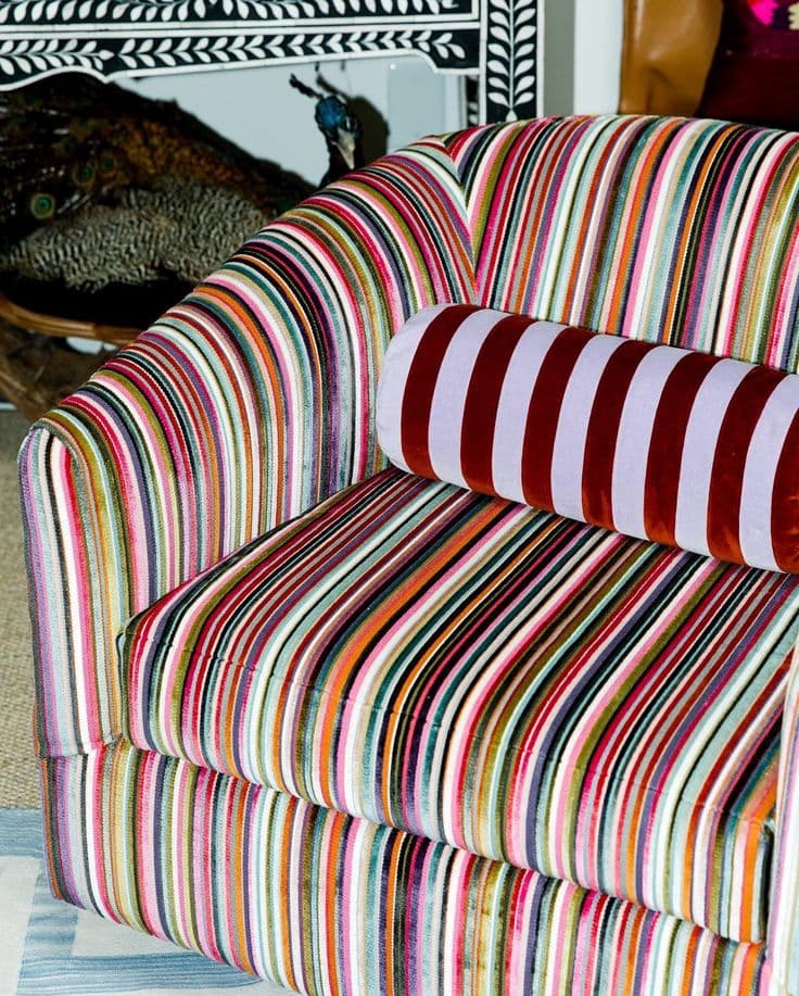 A velvet armchair in multicoloured stripes